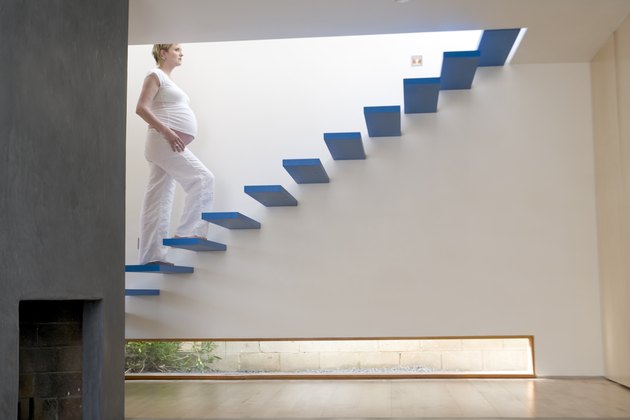 Pregnant woman walking up stairs