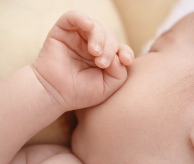 Newborn sucks mother's breast, breastfeeding