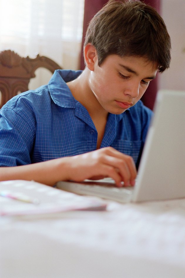 Young boy at work on laptop