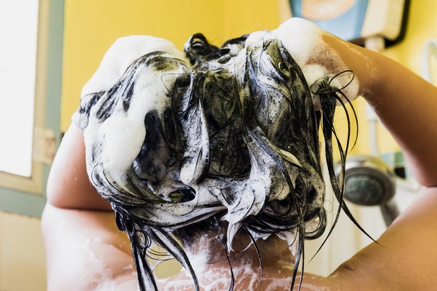 woman washing hair with shampoo, healthcare