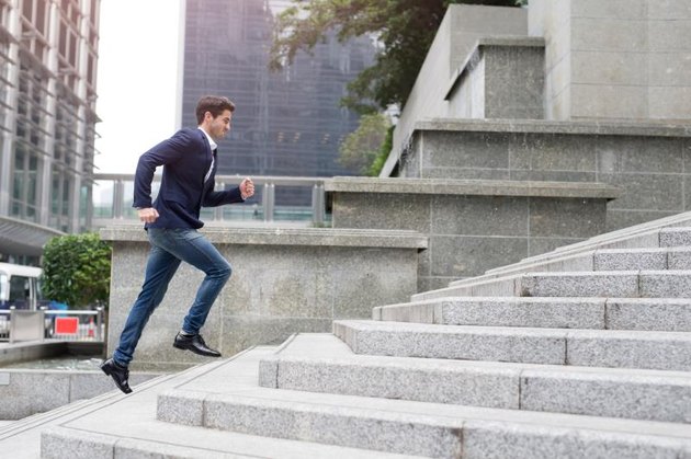 Businessman in hurry. Motion blurred people over office building in hongkong