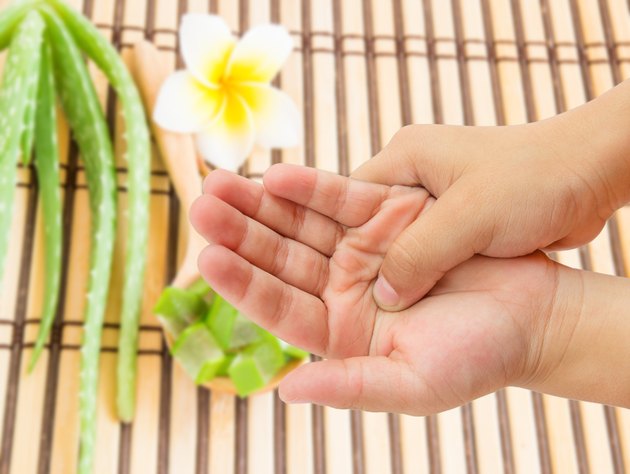hand pain with blurred aloe vera background