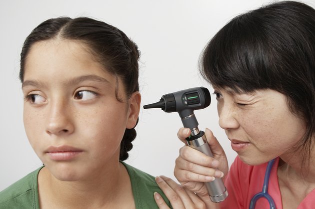 Doctor examining girl in hospital