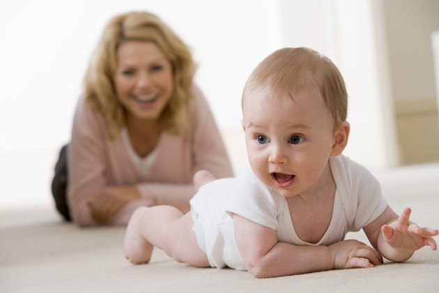 Mother watching crawling baby