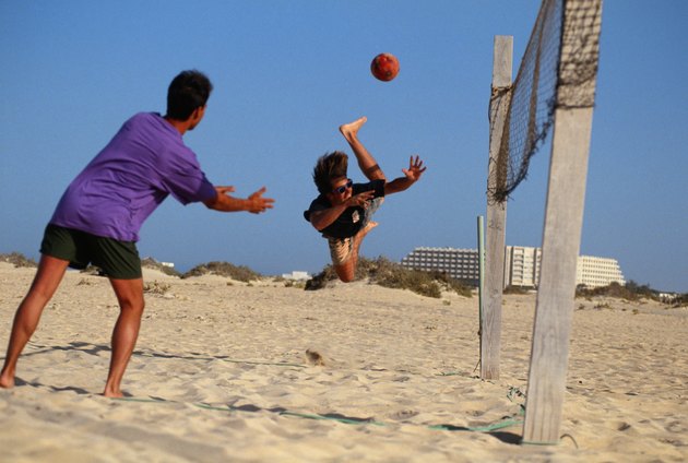 Men playing beach volleyball