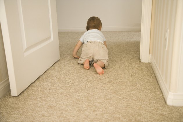 Baby crawling through doorway