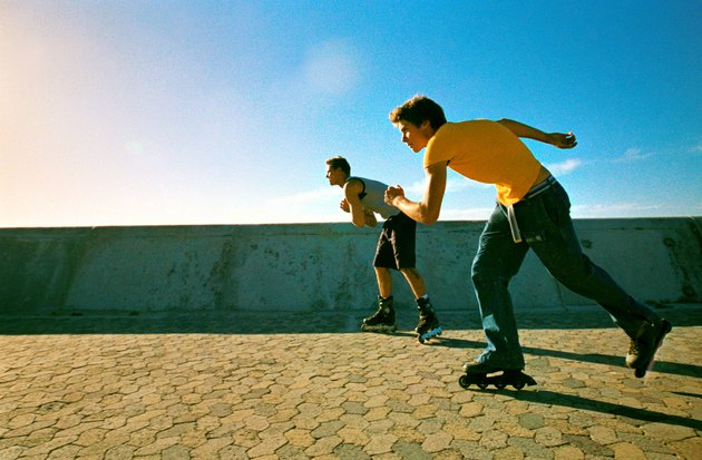 Two young men skating with in-line skates