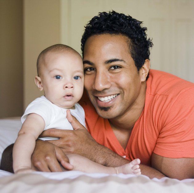 Father and son on a bed