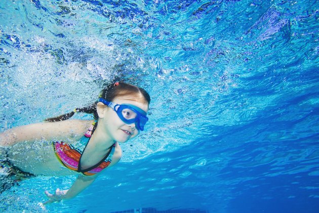 Underwater shot of Asian girl swimming