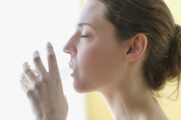 Young woman drinking a glass of water