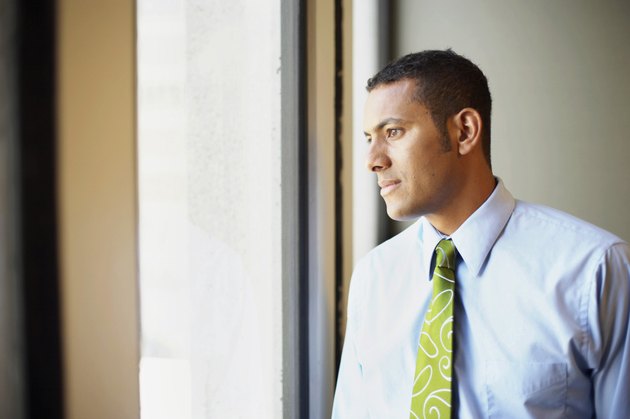 Businessman looking through window