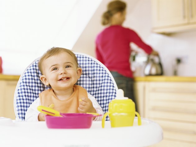 close-up of a baby girl sitting on a high chair
