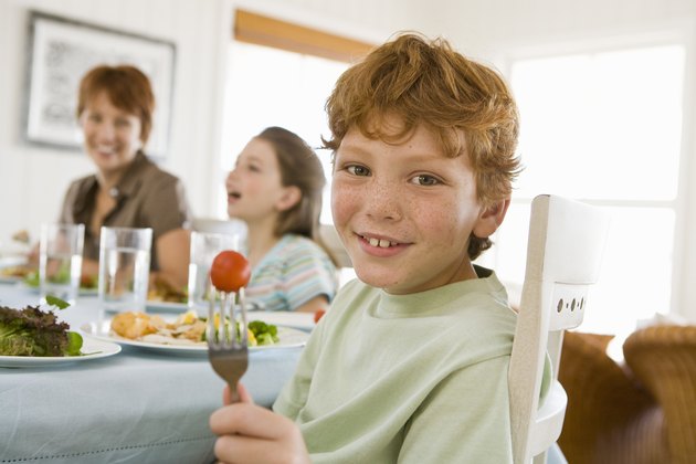 Boy eating at table