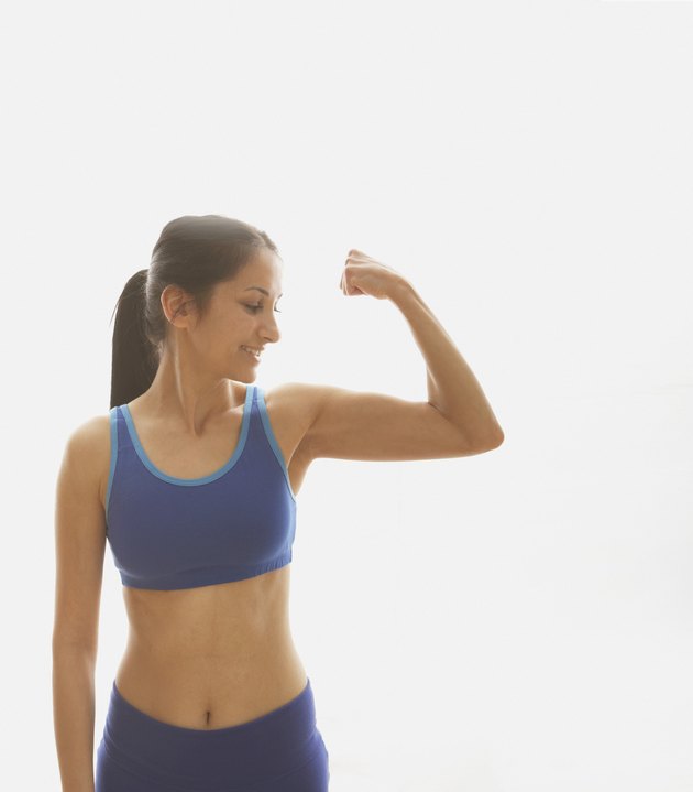 Young woman flexing her muscles