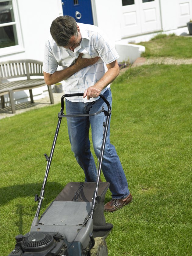 Man with chest pain mowing lawn