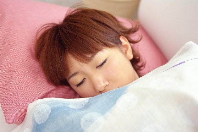 Closed Up Image of a Young Woman Sleeping on a Pink Pillow, High Angle View