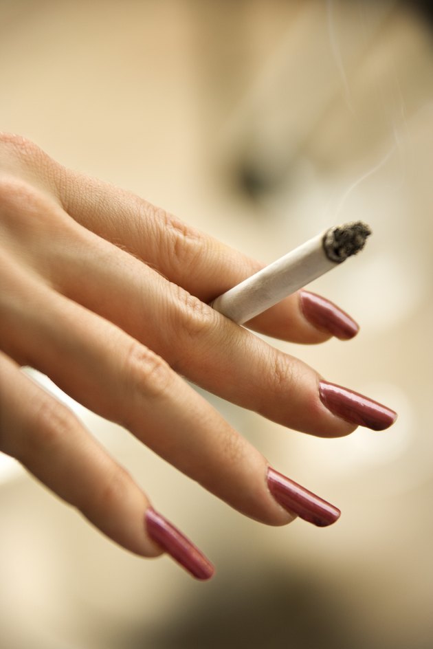 Hand of woman holding cigarette