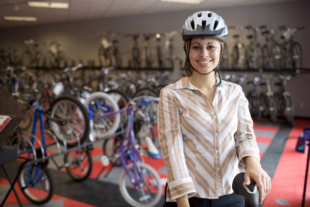 Woman in safety helmet in bike shop