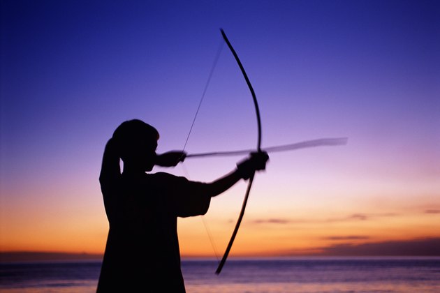 Boy shooting bow and arrow