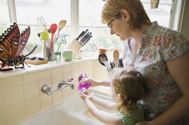 Mother and daughter washing hands