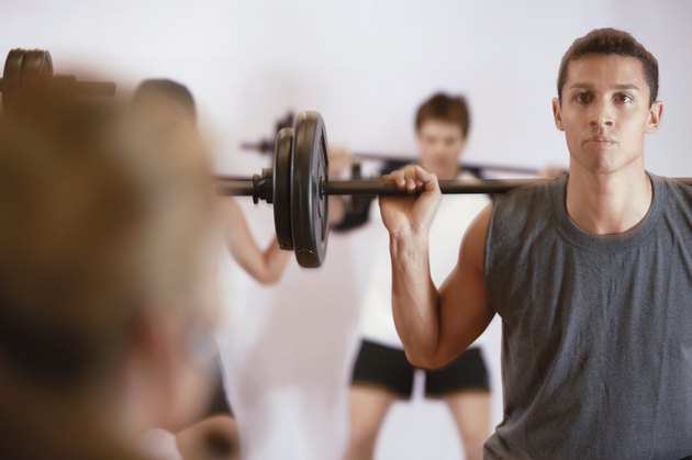 Man lifting weights in exercise class