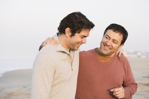 Hispanic friends walking on beach