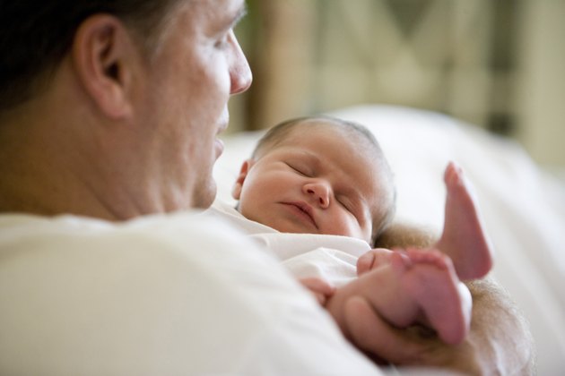 Mid adult man holding his baby