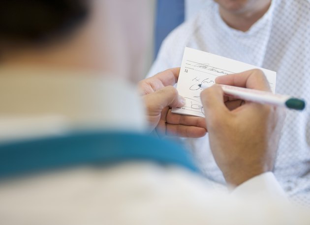 Doctor Filling Out Prescription