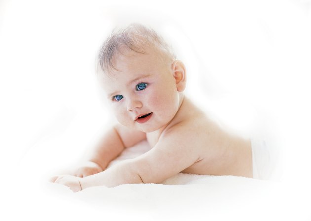 Baby (6-12 months) lying on a bed