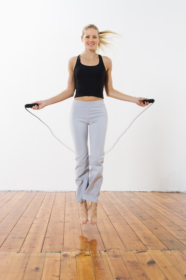 Smiling woman jumping rope