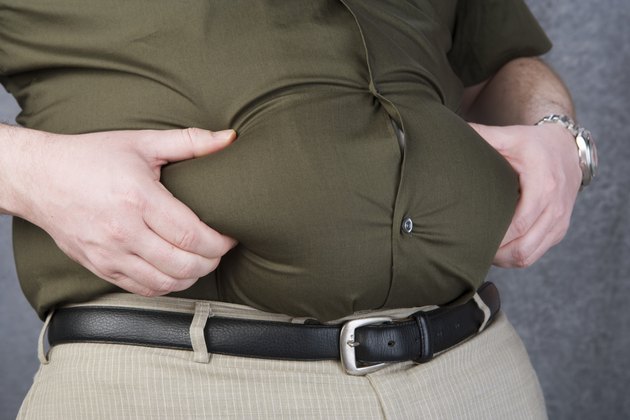 Mid-adult man with hands on belly, mid section