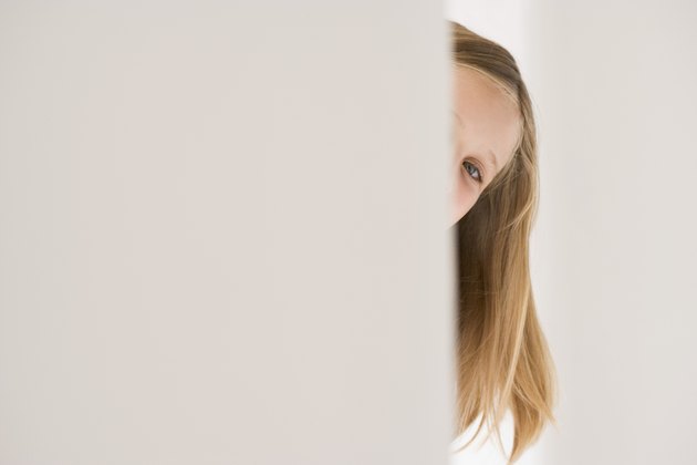 Girl peeking around corner