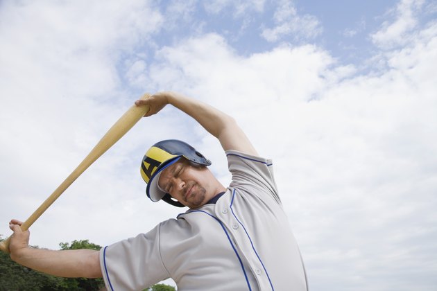 Serious baseball player stretching