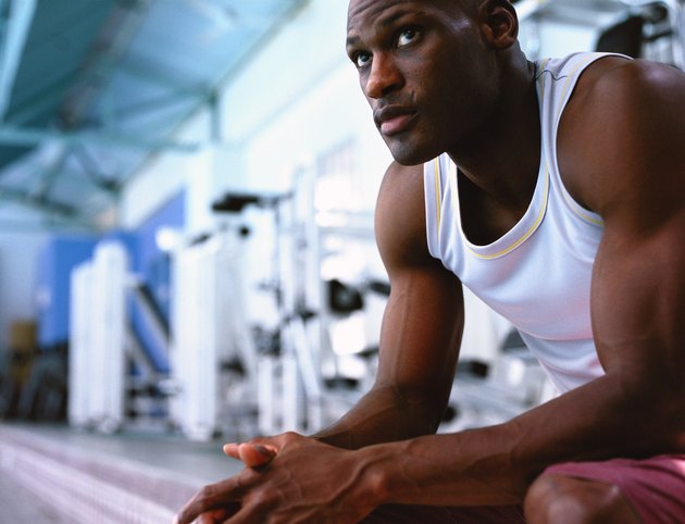 low angle close-up of a man sitting in a gym
