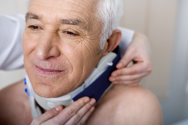 Doctor putting neck brace on patient