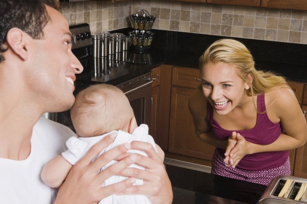 Hispanic mother smiling at baby