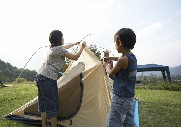 Japanese famliy preparing a camping tent