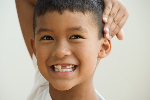 Young boy showing off the gap in his teeth