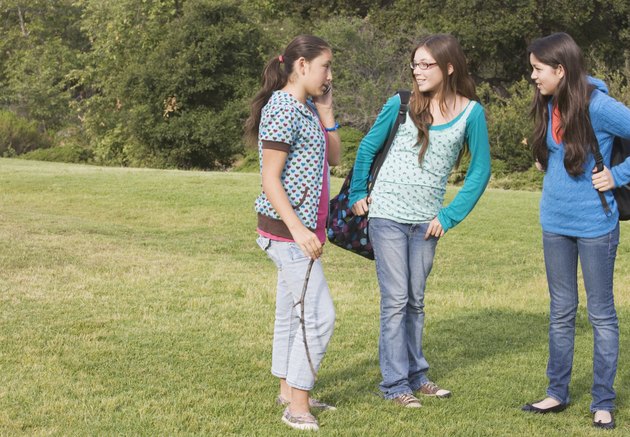 Hispanic teenaged girls in park