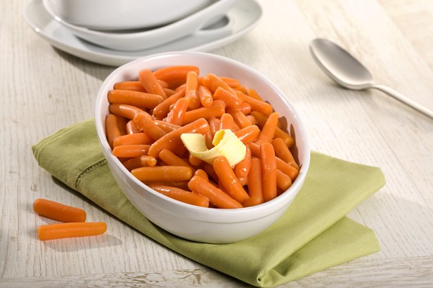baby carrots in white bowl on table