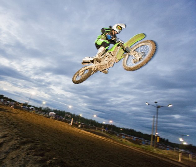 Motorcross rider jumping on track