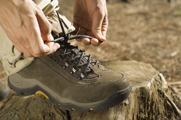 Hands tying shoe