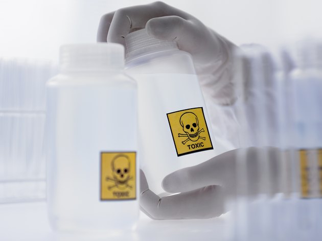 Scientist holding bottle with toxic label