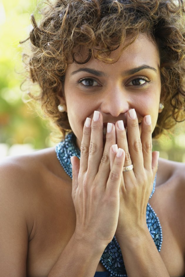 South American woman covering mouth