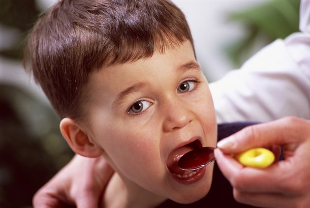 Boy taking liquid medicine