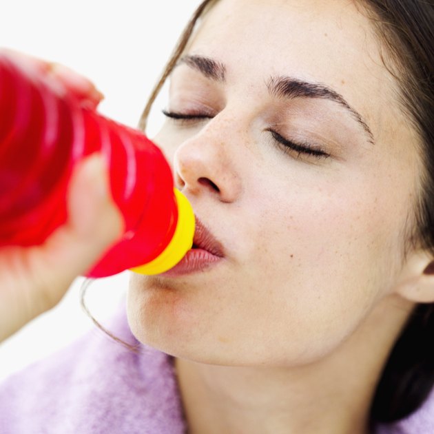 Close-up of a young woman drinking water from a bottle