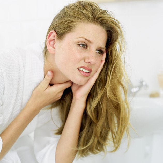 close-up of a young woman with her hands on her neck