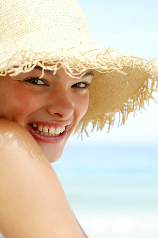 Bashful woman in sunhat