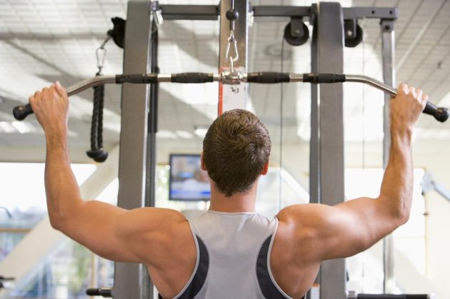 Man Weight Training At Gym