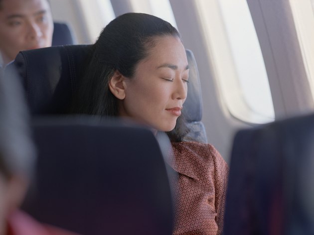 Woman sleeping in an airplane seat
